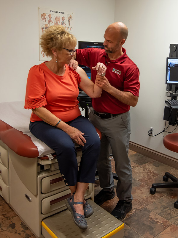 doctor providing shoulder exam