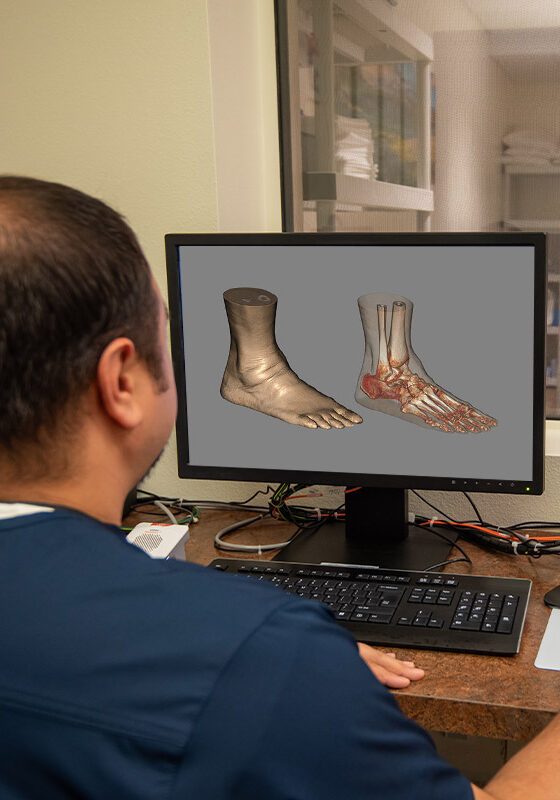 technician looking at a 3d model of a foot and ankle